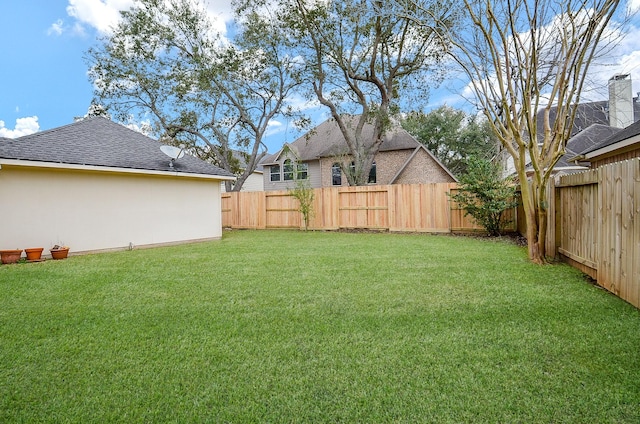 view of yard with a fenced backyard