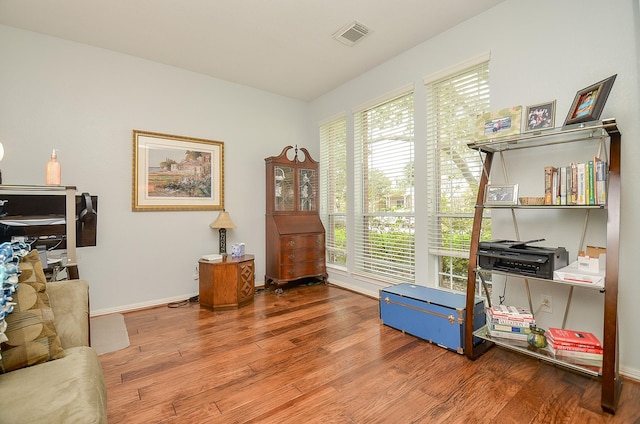 office with visible vents, baseboards, and wood finished floors