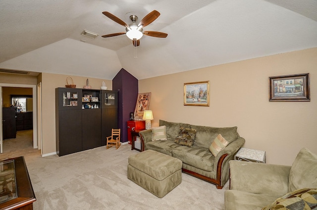 living area with visible vents, carpet floors, ceiling fan, and vaulted ceiling