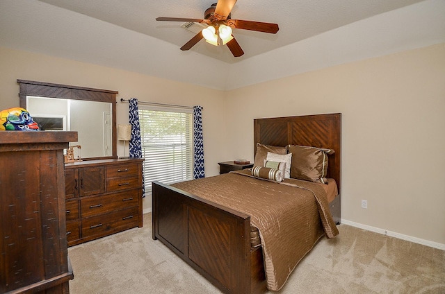 bedroom featuring baseboards, light colored carpet, lofted ceiling, and ceiling fan