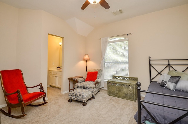 bedroom featuring visible vents, light carpet, connected bathroom, and vaulted ceiling