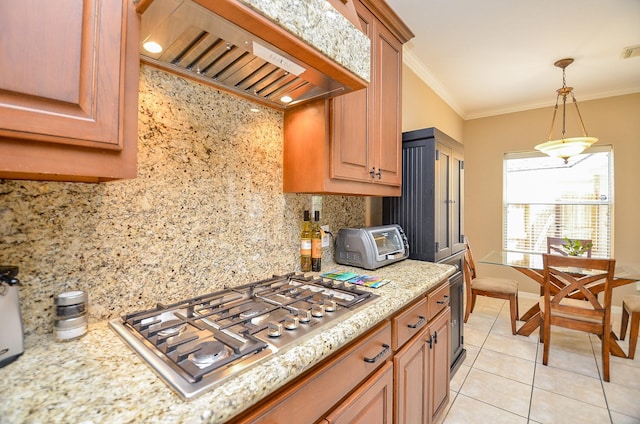 kitchen with light tile patterned floors, crown molding, custom range hood, and stainless steel gas stovetop