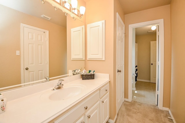 bathroom with vanity, baseboards, and visible vents