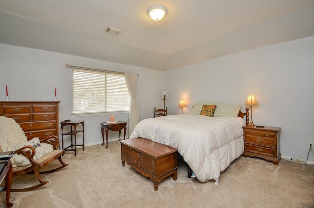 bedroom featuring visible vents and light carpet