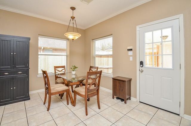 dining room featuring light tile patterned floors, baseboards, and ornamental molding