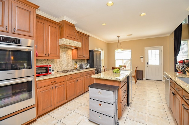 kitchen with tasteful backsplash, brown cabinetry, stainless steel appliances, and crown molding