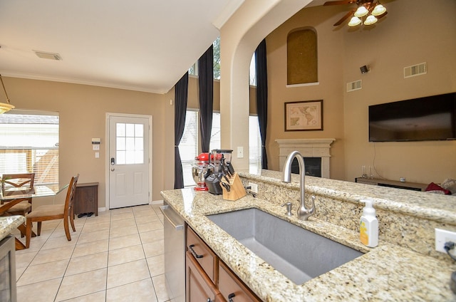 kitchen with visible vents, dishwasher, crown molding, and a sink