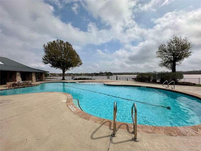 pool with a patio and fence