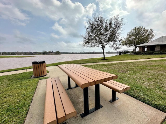 view of home's community featuring a yard and a water view