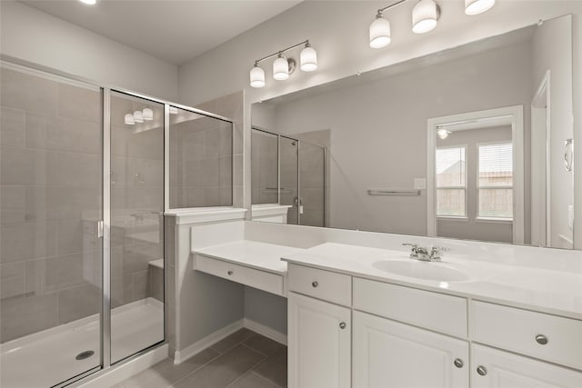 full bathroom featuring tile patterned floors, a stall shower, and vanity