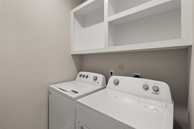 clothes washing area with independent washer and dryer and laundry area