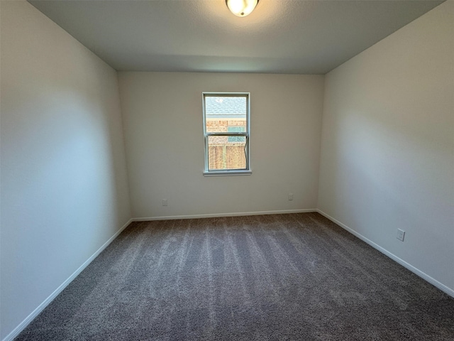 19127 Hazel Firs Ln, Magnolia, TX 77355 - unfurnished room with baseboards and dark colored carpet
