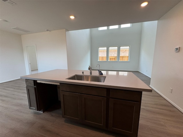 19127 Hazel Firs Ln, Magnolia, TX 77355 - kitchen featuring a sink, wood finished floors, open floor plan, light countertops, and recessed lighting