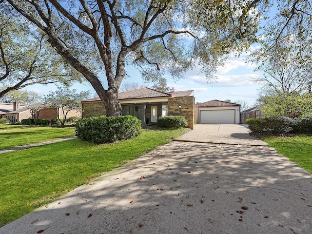 view of front of house featuring a garage, a chimney, a front lawn, and a tiled roof