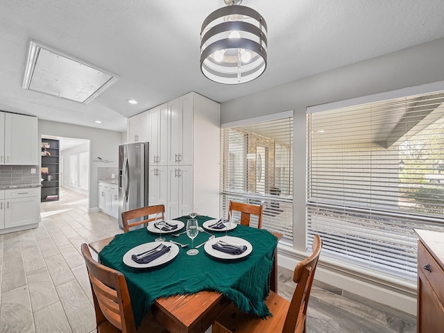 dining room featuring attic access and recessed lighting