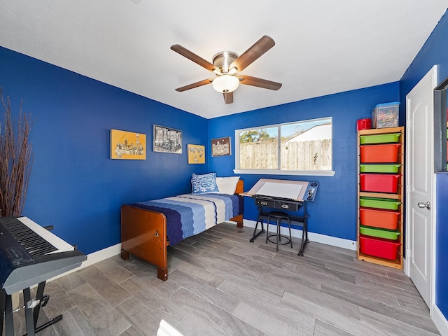 bedroom featuring a ceiling fan, baseboards, and wood finish floors