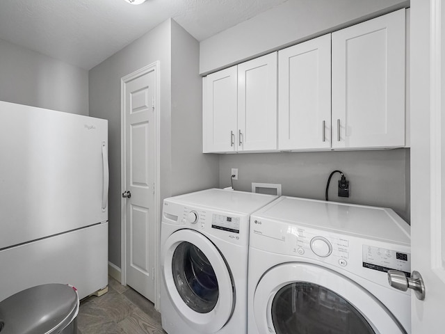 laundry area with cabinet space and independent washer and dryer