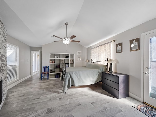 bedroom featuring ceiling fan, baseboards, lofted ceiling, and wood finished floors