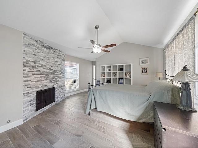 unfurnished bedroom with baseboards, a fireplace, a ceiling fan, and lofted ceiling