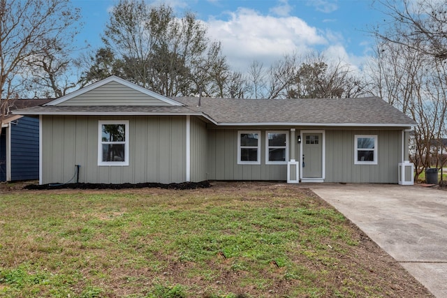 single story home with a front yard and roof with shingles