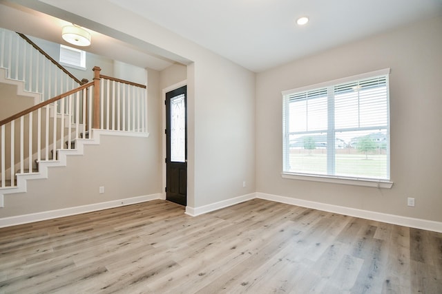 spare room with stairway, recessed lighting, baseboards, and wood finished floors