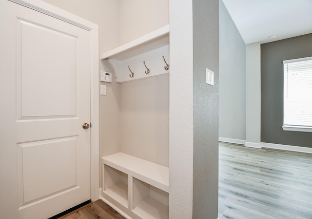 mudroom with wood finished floors and baseboards