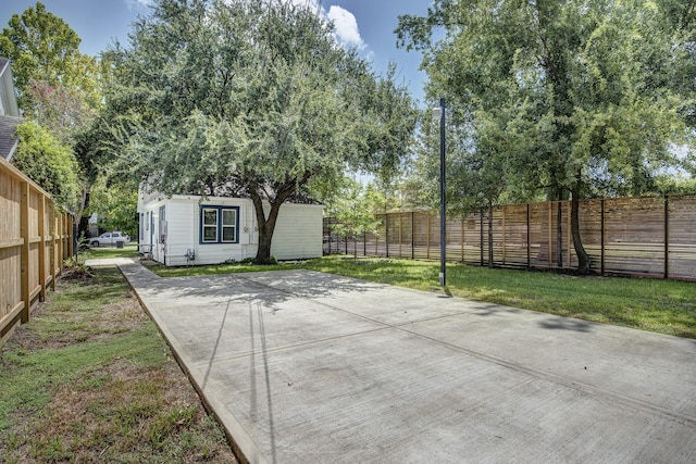 view of patio / terrace with an outbuilding and a fenced backyard