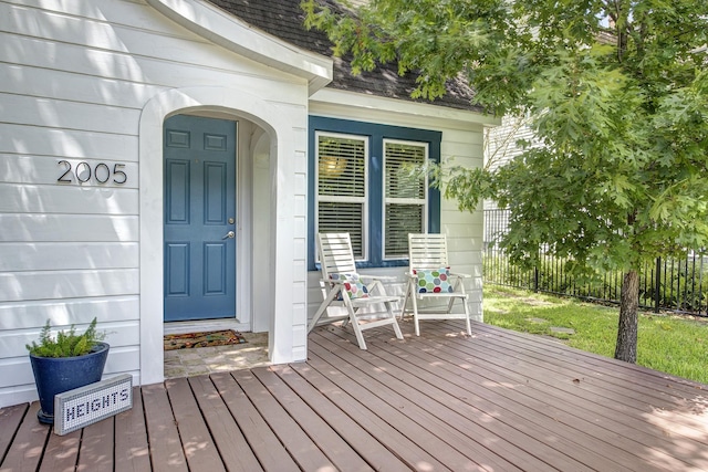 wooden terrace featuring fence