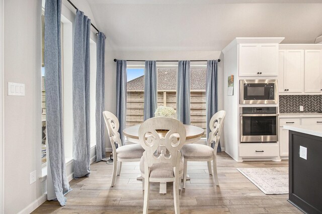 dining room with baseboards and light wood-style floors