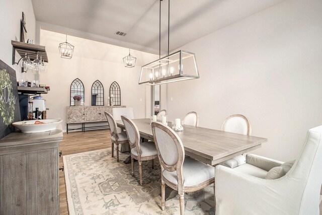 dining room featuring wood finished floors and visible vents