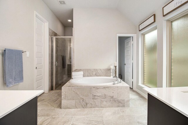 bathroom with vanity, visible vents, vaulted ceiling, a shower stall, and a bath