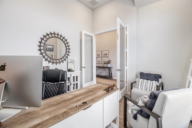 office with visible vents, light wood-style flooring, and french doors