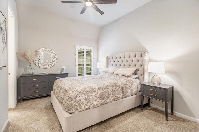 bedroom featuring light carpet, a ceiling fan, lofted ceiling, and baseboards