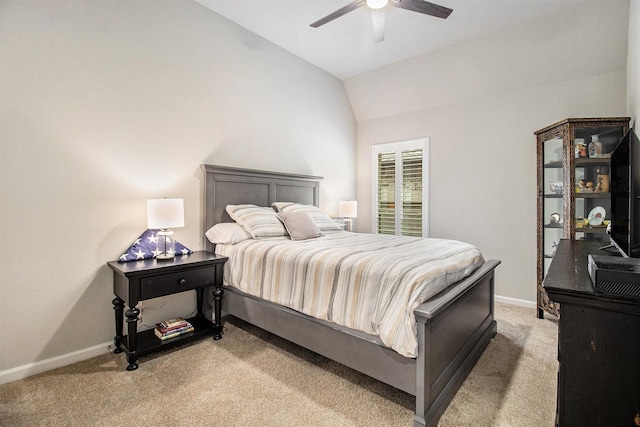bedroom with baseboards, light carpet, ceiling fan, and vaulted ceiling