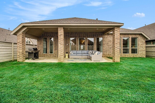 back of property featuring a fenced backyard, a patio area, a shingled roof, and brick siding