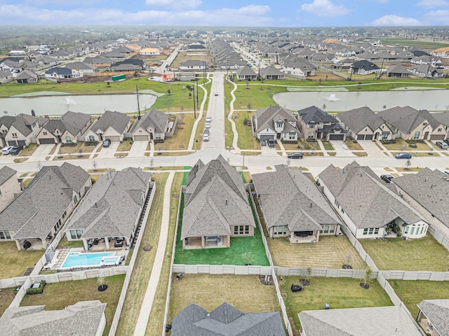 birds eye view of property featuring a residential view and a water view