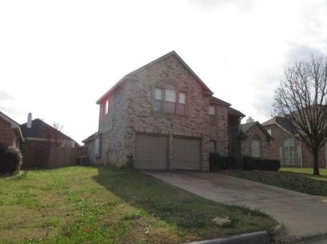 traditional home with a garage, central AC, concrete driveway, and a front yard