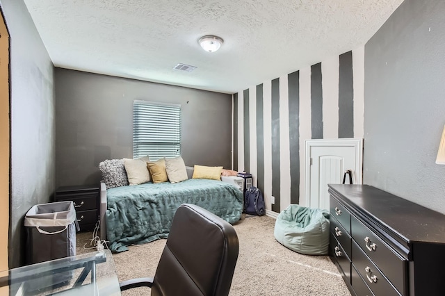 carpeted bedroom with visible vents and a textured ceiling