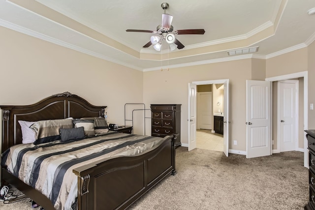 bedroom with visible vents, a raised ceiling, light carpet, and ornamental molding