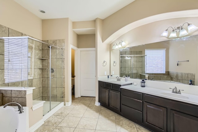 full bath with a sink, a garden tub, a stall shower, and double vanity