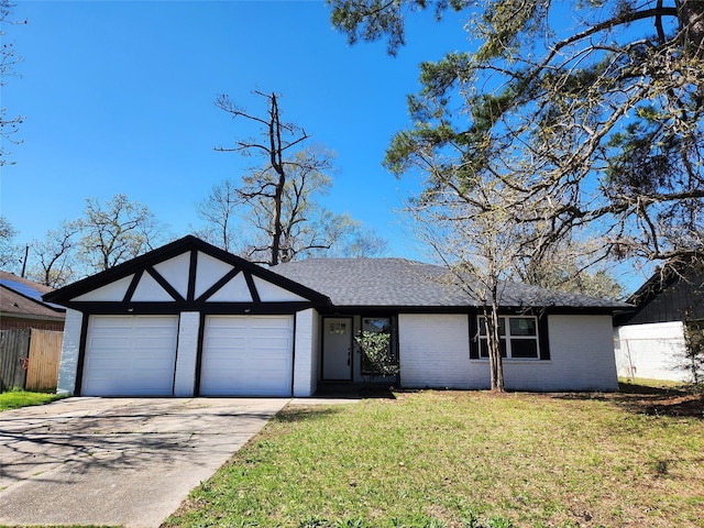 view of front facade featuring a front yard, fence, driveway, a garage, and brick siding