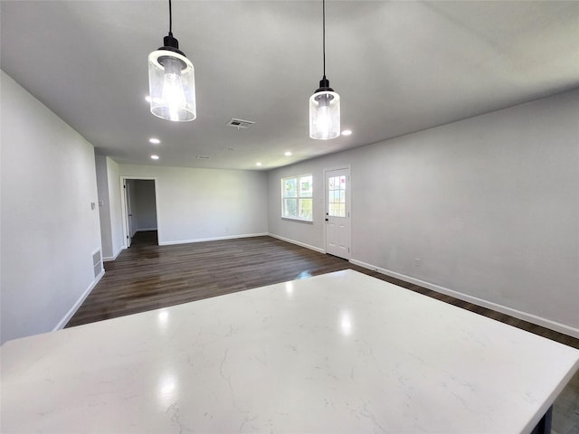 unfurnished room featuring recessed lighting, baseboards, visible vents, and dark wood-style flooring