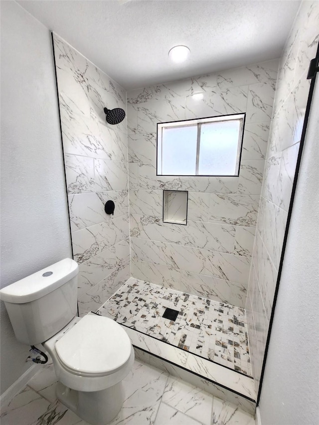 full bath with a textured ceiling, toilet, marble finish floor, and a stall shower