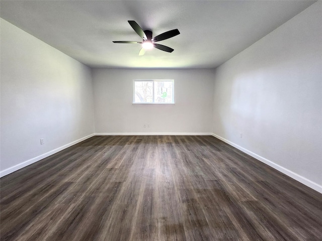 unfurnished room with a ceiling fan, dark wood-style floors, and baseboards