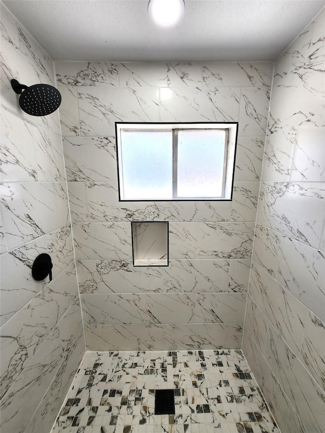 full bath featuring a tile shower