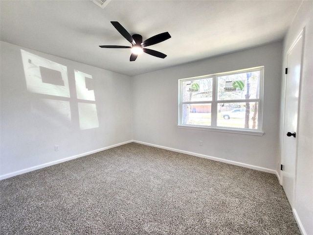 carpeted empty room with a ceiling fan and baseboards