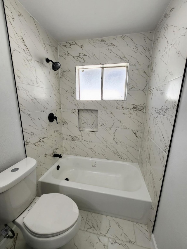 bathroom with marble finish floor, toilet, and bathing tub / shower combination