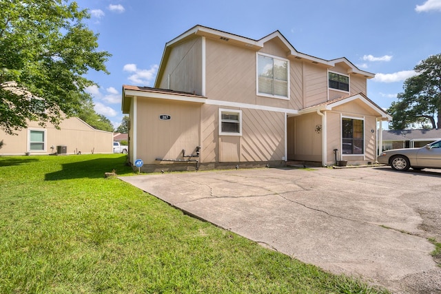 view of front of home with a front lawn and central air condition unit