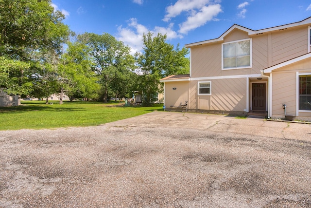 back of property featuring a yard