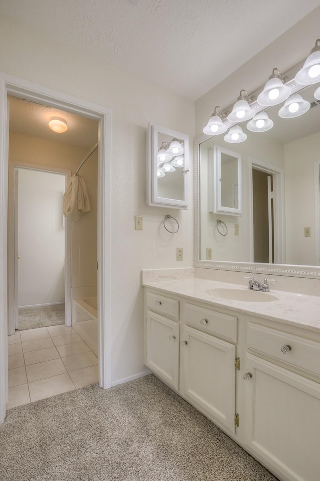 full bath with tile patterned floors, shower / tub combination, a textured ceiling, baseboards, and vanity